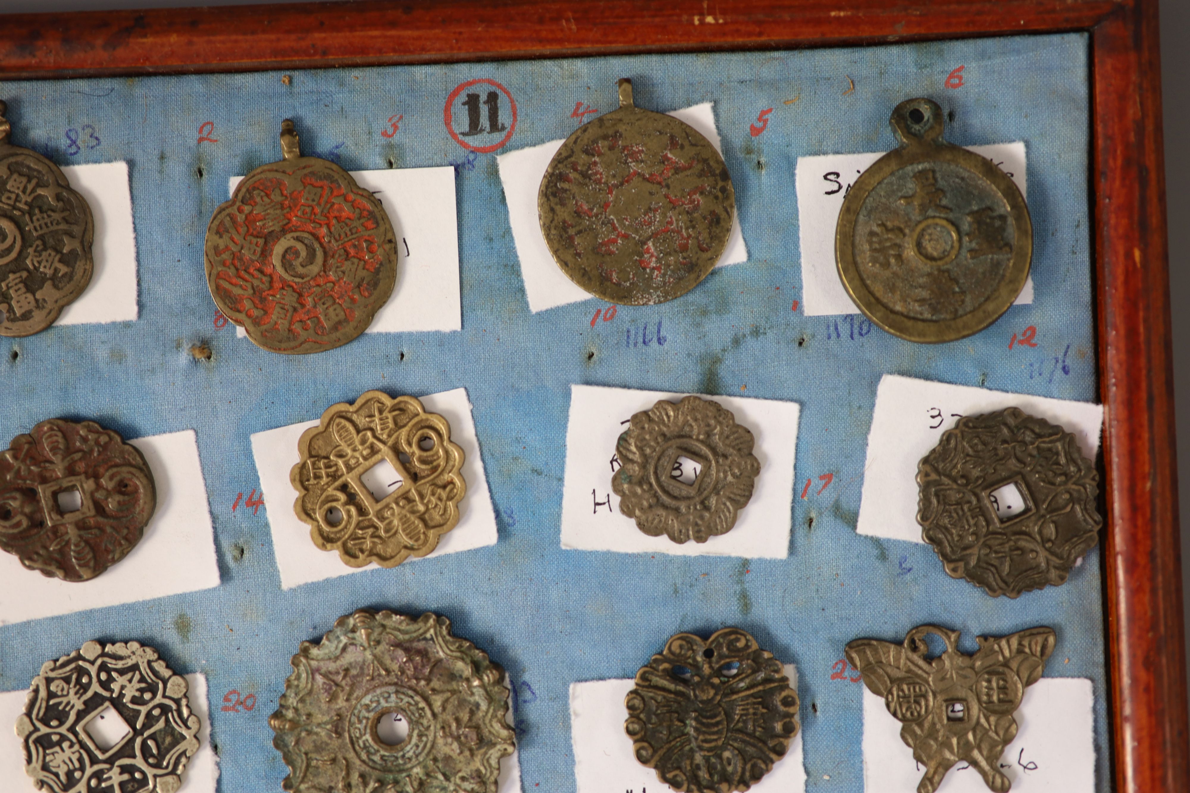 A group of 99 Korean bronze and metal amulets or charms, 19th/20th century